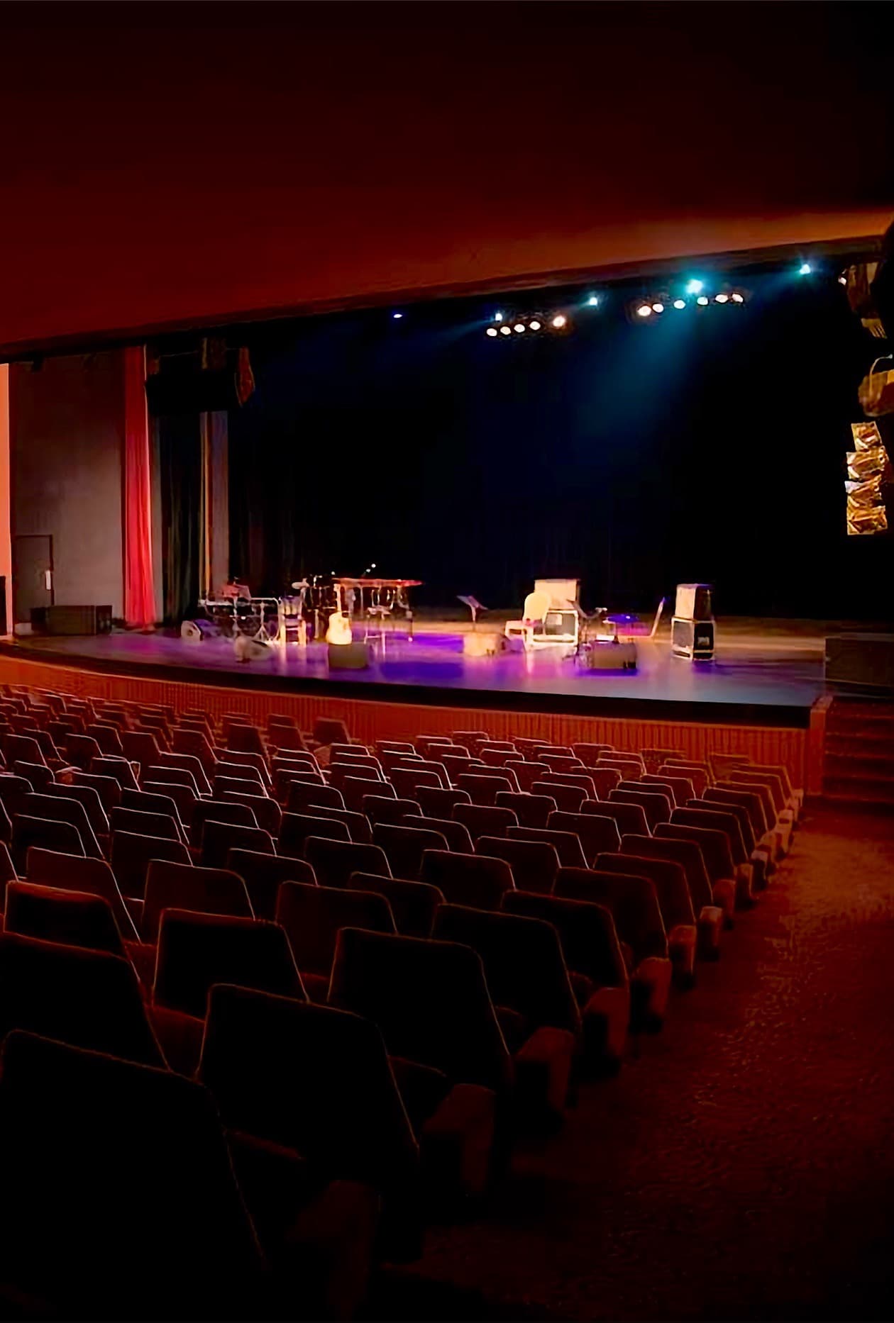 The Casino du Liban Theater stage, lit, seen across the empty rows